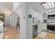 Bright kitchen with stainless steel appliances, light wood flooring and open access to dining area at 2092 S Helena St # C, Aurora, CO 80013