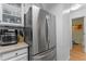 Stainless steel refrigerator blends into the warm, white kitchen decor at 2092 S Helena St # C, Aurora, CO 80013