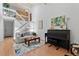 Open-concept living room featuring a piano, staircase, and natural light at 2092 S Helena St # C, Aurora, CO 80013