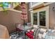 Cozy patio features a table, chairs, umbrella, and glass door to enjoy the outdoors at 2092 S Helena St # C, Aurora, CO 80013