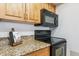 Kitchen with microwave and electric stovetop at 4896 S Dudley St # 7-7, Littleton, CO 80123
