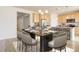 This dining room features a gorgeous dark marble table, seating for eight, and is adjacent to the kitchen at 1462 Raindrop Way, Castle Rock, CO 80109
