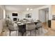 Dining area with modern table and chair set near a living room with fireplace at 1462 Raindrop Way, Castle Rock, CO 80109