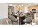Dining and kitchen area with table, bar stool seating, and chandelier lighting at 1462 Raindrop Way, Castle Rock, CO 80109