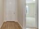Bright foyer featuring hardwood floors and a view into a carpeted living space at 1462 Raindrop Way, Castle Rock, CO 80109