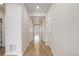 Bright hallway with wood floors and white walls, leading to various rooms in the home at 1462 Raindrop Way, Castle Rock, CO 80109