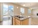 Kitchen with center island with bar seating and sliding doors to deck at 1462 Raindrop Way, Castle Rock, CO 80109