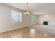 Living room with fireplace, hardwood floors, chandelier, and natural light at 1462 Raindrop Way, Castle Rock, CO 80109