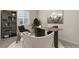 Home office showcasing a wooden desk, decorative shelving, and a comfortable seating area at 1462 Raindrop Way, Castle Rock, CO 80109