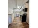 Kitchen with appliances and wood-look floors at 2401 S Gaylord St # 103, Denver, CO 80210