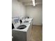 Shared laundry room with coin-operated washers and dryers at 2401 S Gaylord St # 103, Denver, CO 80210