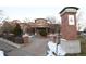 Community building entrance with brick pillars and landscaping at 4100 Albion St # 504, Denver, CO 80216