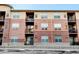 Brick building exterior with multiple units and balconies at 4100 Albion St # 504, Denver, CO 80216