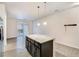 Granite kitchen island with dark cabinets and pendant lighting at 4100 Albion St # 504, Denver, CO 80216