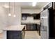 Modern kitchen with dark cabinetry, granite countertops, and stainless steel appliances at 4100 Albion St # 504, Denver, CO 80216