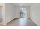 Bright living room with wood-look floors and access to a private balcony at 4100 Albion St # 504, Denver, CO 80216