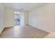 Living room with wood-look floors and sliding glass door to balcony at 4100 Albion St # 504, Denver, CO 80216