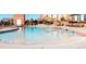 Relaxing community pool with lounge chairs and umbrellas at 4100 Albion St # 504, Denver, CO 80216