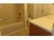 Bright bathroom featuring a bathtub and shower combination next to a vanity with a white countertop at 453 S Kittredge St # D, Aurora, CO 80017