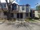 Traditional two-story townhome featuring black door and neutral siding, showcasing classic charm at 453 S Kittredge St # D, Aurora, CO 80017