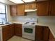 Bright kitchen with oak cabinets, white countertops, and modern appliances, providing ample workspace at 453 S Kittredge St # D, Aurora, CO 80017