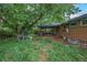 Lush backyard featuring a covered patio, mature trees, and ample space for outdoor activities and relaxation at 3273 S Florence Ct, Denver, CO 80231
