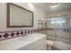 Bathroom with a white vanity, decorative tile, and a shower/tub combination with a glass enclosure at 3273 S Florence Ct, Denver, CO 80231