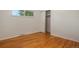Bright bedroom with hardwood floors, a window, and a closet, providing a simple and inviting space at 3273 S Florence Ct, Denver, CO 80231