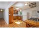 Bright kitchen featuring hardwood floors, a skylight, wood cabinetry, and stainless steel appliances at 3273 S Florence Ct, Denver, CO 80231