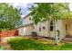 Rear exterior view featuring a fenced yard and shade trees at 12825 Forest Way, Thornton, CO 80241