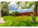 Green backyard featuring a lush lawn and privacy fence at 12825 Forest Way, Thornton, CO 80241