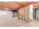Unfinished basement featuring exposed wood ceilings, bare concrete floors, and a framed stairwell at 12825 Forest Way, Thornton, CO 80241