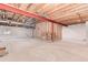 Unfinished basement featuring exposed wood ceilings, bare concrete floors, and a framed stairwell at 12825 Forest Way, Thornton, CO 80241