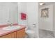 Well-lit powder room with a light countertop and wood cabinet at 12825 Forest Way, Thornton, CO 80241