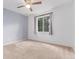 This bedroom features carpet, a ceiling fan, and a window that provides natural light at 12825 Forest Way, Thornton, CO 80241