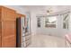 Bright eat-in kitchen with stainless steel refrigerator and plenty of cabinet space at 12825 Forest Way, Thornton, CO 80241