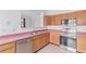 Modern kitchen featuring stainless steel appliances and bright countertops with neutral flooring at 12825 Forest Way, Thornton, CO 80241