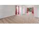 Bright living room with neutral carpet, white walls, and natural light from windows at 12825 Forest Way, Thornton, CO 80241