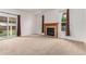 Cozy living area with neutral carpet and a fireplace with wood trim and glass doors at 12825 Forest Way, Thornton, CO 80241