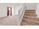 Inviting carpeted staircase leading to the upper level of the home with neutral decor at 12825 Forest Way, Thornton, CO 80241