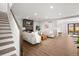 Inviting living room with a modern fireplace, hardwood flooring, neutral decor, staircase, and backyard access at 4144 Depew St, Denver, CO 80212