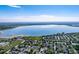 Stunning aerial view of lakeside homes featuring a large lake, lush greenery, and beautiful blue skies on a sunny day at 4825 S Ammons St # 102, Littleton, CO 80123