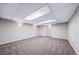 Finished basement with neutral walls, carpet and ample open space for flexible usage at 4825 S Ammons St # 102, Littleton, CO 80123