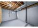 Unfinished basement featuring concrete floor, exposed pipes, and wooden beams, perfect for storage or customization at 4825 S Ammons St # 102, Littleton, CO 80123