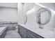 Bathroom featuring double sink vanity with stone countertop, decorative mirrors and tile flooring at 4825 S Ammons St # 102, Littleton, CO 80123