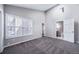 Bedroom featuring neutral walls, carpet, vaulted ceiling and access to the ensuite bathroom at 4825 S Ammons St # 102, Littleton, CO 80123