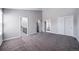 Spacious bedroom featuring neutral walls and carpet with access to ensuite bathroom and walk-in closet at 4825 S Ammons St # 102, Littleton, CO 80123