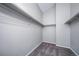Walk-in closet with neutral walls, carpet and built in shelving unit for optimal storage space at 4825 S Ammons St # 102, Littleton, CO 80123