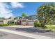 Multi-story townhome showing attached garages, covered entrances, green siding and mature trees at 4825 S Ammons St # 102, Littleton, CO 80123