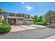 Two-story townhome featuring attached garages, brick accents, covered entry and well maintained landscaping at 4825 S Ammons St # 102, Littleton, CO 80123
